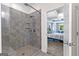 A modern shower with tiled walls and a glass door leading to the bedroom at 105 Turnberry Trce, Sharpsburg, GA 30277