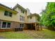 View of the house and backyard featuring a chimney, an exterior basement, and two air conditioning units at 170 River Forest Dr, Fayetteville, GA 30214
