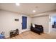 Finished basement features light wood flooring, a dark couch, and access to an outdoor door at 170 River Forest Dr, Fayetteville, GA 30214