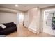 Spacious finished basement with light wood flooring and access to the laundry room and stairs to the main floor at 170 River Forest Dr, Fayetteville, GA 30214