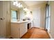 Well-lit bathroom with white vanity, large mirror, and ample counter space for personal care items at 170 River Forest Dr, Fayetteville, GA 30214
