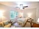 Inviting bedroom with neutral tones, a window with green views, and a cozy yellow chair at 170 River Forest Dr, Fayetteville, GA 30214