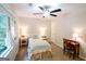Bright bedroom featuring neutral decor, a large window, and a dedicated desk and chair at 170 River Forest Dr, Fayetteville, GA 30214