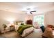 Cozy bedroom with neutral walls, plush carpet, and a window that provides natural light at 170 River Forest Dr, Fayetteville, GA 30214