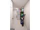 Functional laundry room features stacked washer and dryer, storage shelves, and bright tile flooring at 170 River Forest Dr, Fayetteville, GA 30214