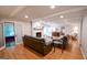Open-concept living room with stone fireplace, wood floors, comfortable seating, and sliding doors for easy access to outdoors at 170 River Forest Dr, Fayetteville, GA 30214