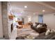 Spacious living room with stone fireplace, wood floors, comfortable sofas, and piano perfect for relaxation and entertainment at 170 River Forest Dr, Fayetteville, GA 30214