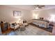 Spacious main bedroom featuring ceiling fan, hardwood floors, rug, lamps, and two chairs at 170 River Forest Dr, Fayetteville, GA 30214