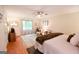 Bright main bedroom featuring a ceiling fan and a sitting area with large, sunlit windows at 170 River Forest Dr, Fayetteville, GA 30214