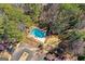 Aerial view of a private backyard swimming pool surrounded by lush trees at 53 Cobblestone Crk, Peachtree City, GA 30269