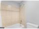 Close up on the shower/tub combo with a shower curtain and tiled enclosure at 53 Cobblestone Crk, Peachtree City, GA 30269