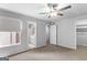 This spacious bedroom features neutral carpet, ceiling fan, a private bathroom and closet at 53 Cobblestone Crk, Peachtree City, GA 30269