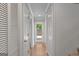 Clean hallway with white doors and trim leading to a backyard entrance at 53 Cobblestone Crk, Peachtree City, GA 30269