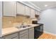 Updated kitchen featuring grey cabinets, modern appliances, and tile backsplash at 53 Cobblestone Crk, Peachtree City, GA 30269