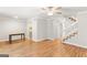 Spacious living room with hardwood floors, stairs, and an adjacent kitchen at 53 Cobblestone Crk, Peachtree City, GA 30269