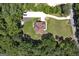 Aerial view showing roof and well-maintained lawn, and long driveway in a heavily wooded area at 20 Allie Dr, Mcdonough, GA 30252