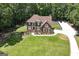 Aerial view of the property showcasing a well-manicured lawn, mature trees, and a long private driveway at 20 Allie Dr, Mcdonough, GA 30252