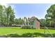 Exterior view of home showcasing back facade, outdoor entertainment space, and lush yard at 20 Allie Dr, Mcdonough, GA 30252