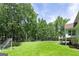 Lush backyard with mature trees, a soccer goal, and an outdoor entertainment area at 20 Allie Dr, Mcdonough, GA 30252