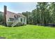 Expansive backyard with lush greenery, mature trees, and outdoor seating area at 20 Allie Dr, Mcdonough, GA 30252