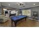 Basement with a pool table, foosball table, and a view into the bright kitchen and bar seating at 20 Allie Dr, Mcdonough, GA 30252
