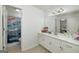 Bathroom featuring dual-sink vanity with ample counter space and colorful shower curtain at 20 Allie Dr, Mcdonough, GA 30252