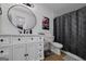 Stylish bathroom featuring a white vanity, round mirror, and a modern, decorative shower curtain at 20 Allie Dr, Mcdonough, GA 30252