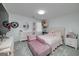 Bright pink bedroom featuring a plush chaise lounge, decorative dresser, and cozy carpet at 20 Allie Dr, Mcdonough, GA 30252