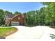 Long driveway leading to a brick home with an attached garage and ample parking space at 20 Allie Dr, Mcdonough, GA 30252