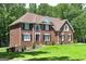 Traditional brick home featuring manicured landscaping and a well-maintained lawn at 20 Allie Dr, Mcdonough, GA 30252