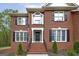 Charming brick home with a well-manicured front yard, steps leading to the front door, and black shutters at 20 Allie Dr, Mcdonough, GA 30252