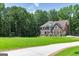 Spacious two-story brick home with a long driveway and expansive front lawn at 20 Allie Dr, Mcdonough, GA 30252