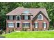 Charming brick home with black shutters, manicured lawn, and mature landscaping at 20 Allie Dr, Mcdonough, GA 30252