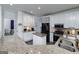 Modern kitchen featuring granite counters, white cabinets, and stainless steel appliances at 20 Allie Dr, Mcdonough, GA 30252