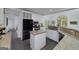 Bright kitchen with white cabinetry, granite countertops, and an island at 20 Allie Dr, Mcdonough, GA 30252