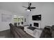 Cozy living room with fireplace, large windows, and a comfortable gray sofa at 20 Allie Dr, Mcdonough, GA 30252
