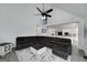 Open-concept living room featuring a large sectional sofa, modern ceiling fan, and views into kitchen at 20 Allie Dr, Mcdonough, GA 30252