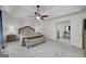 Spacious main bedroom with neutral tones, ceiling fan, and en-suite bathroom access at 20 Allie Dr, Mcdonough, GA 30252
