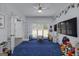 Vibrant playroom with blue carpet, a ceiling fan, and lots of toys and play areas for  at 20 Allie Dr, Mcdonough, GA 30252