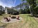 Spacious backyard featuring a fire pit area and a screened-in porch at 1122 Montclair Dr, Peachtree City, GA 30269