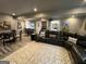 Finished basement featuring a wet bar, large sectional sofa and open living space at 1122 Montclair Dr, Peachtree City, GA 30269