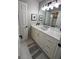 This bright bathroom features a white vanity, light fixtures, and a decorative rug at 1122 Montclair Dr, Peachtree City, GA 30269