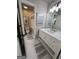This bathroom features a white vanity, light fixtures, and a view to another room at 1122 Montclair Dr, Peachtree City, GA 30269