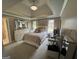 This bedroom features a tray ceiling, windows for natural light, and comfortable neutral decor at 1122 Montclair Dr, Peachtree City, GA 30269