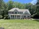 Charming two-story home with a covered front porch and well-manicured lawn at 1122 Montclair Dr, Peachtree City, GA 30269