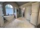 This bright main bathroom features a soaking tub, tiled floors, and a glass shower enclosure at 1122 Montclair Dr, Peachtree City, GA 30269