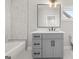 Modern bathroom features a vanity with gray cabinetry, a white countertop and bathtub at 2018 Presley, Atlanta, GA 30317