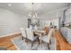 Elegant dining room with tray ceiling, modern chandelier, and adjacent kitchen area at 2018 Presley, Atlanta, GA 30317