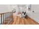 Hallway with hardwood floors, white walls, and modern railing leading to an upstairs living area at 2018 Presley, Atlanta, GA 30317