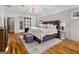 Bright main bedroom featuring hardwood floors, tray ceiling, and stylish sliding barn door at 2018 Presley, Atlanta, GA 30317